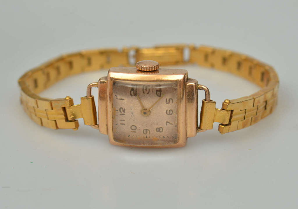Gold wristwatch with metal strap