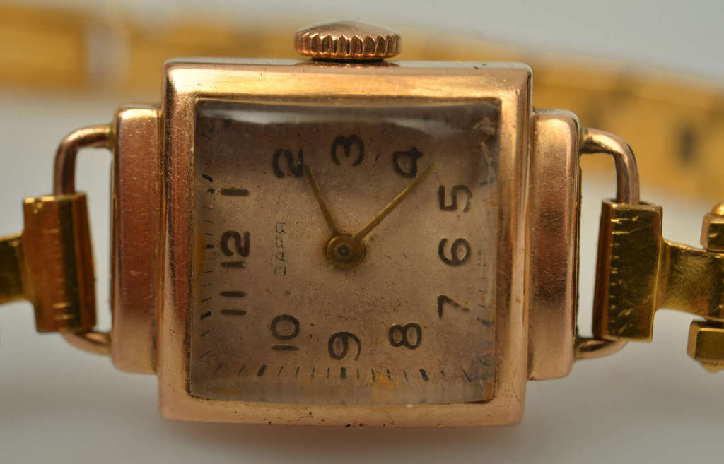 Gold wristwatch with metal strap