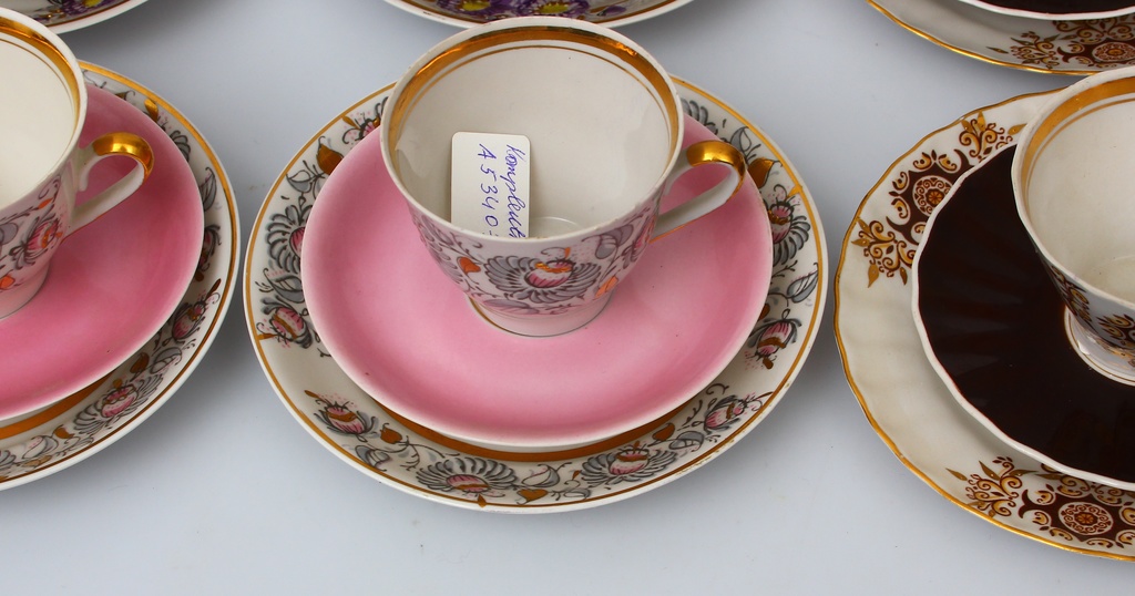 Set of different porcelain cups, saucers and plates