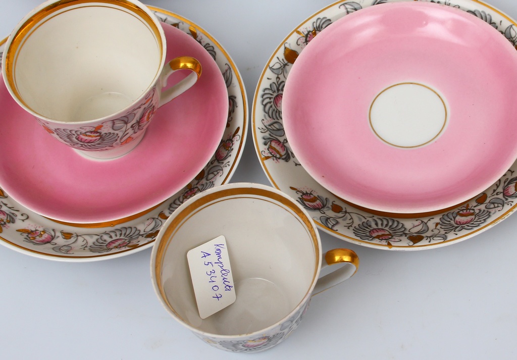 Set of different porcelain cups, saucers and plates