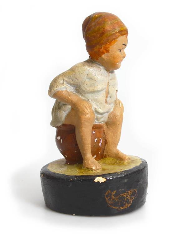 Figurine boy on the toilet