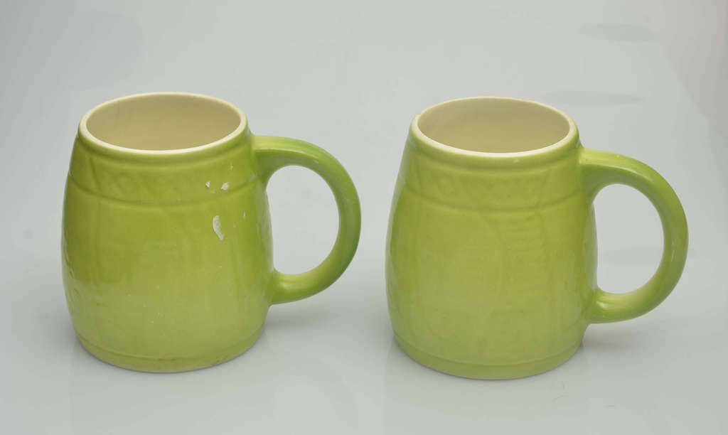 Two porcelain beer cups in green