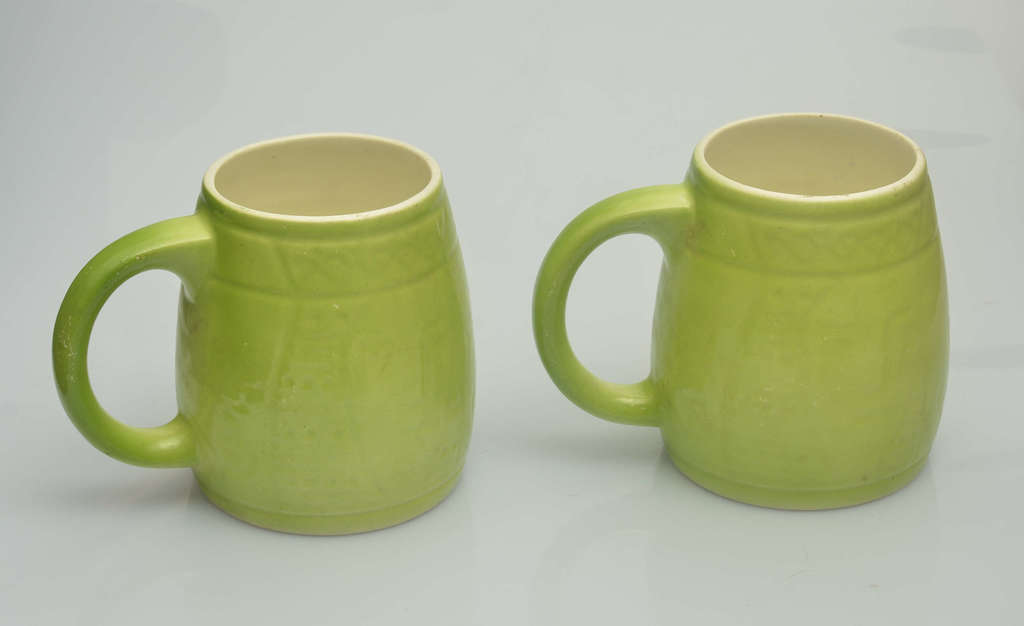 Two porcelain beer cups in green