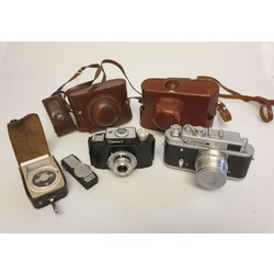 2 cameras in a leather case and an exposure meter