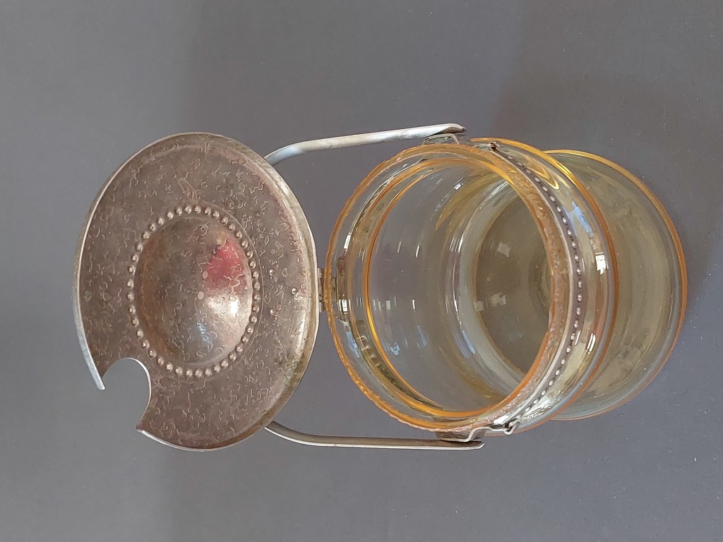 Glass container with a metal lid