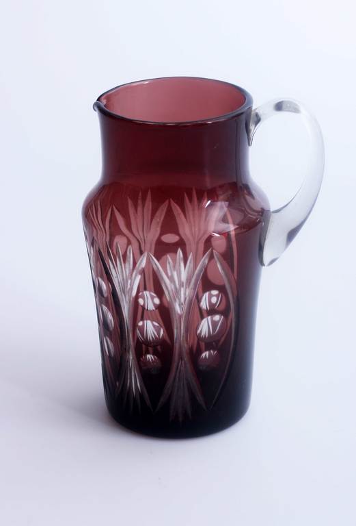 Glass jug with polished ornament