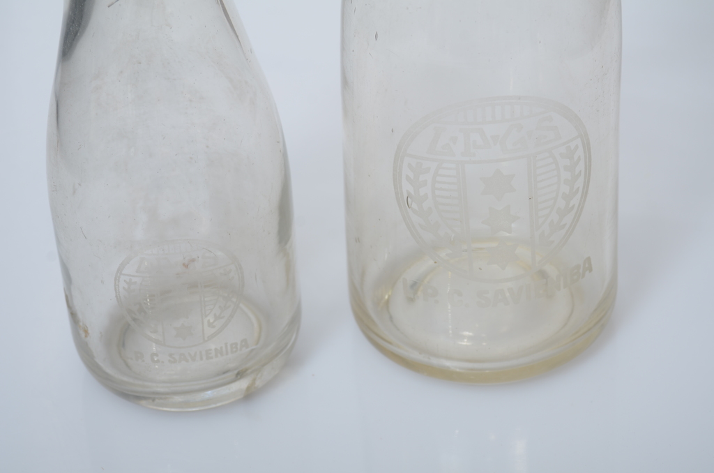 Milk bottles with the coat of arms of the Latvian Dairy Farmers' Union.