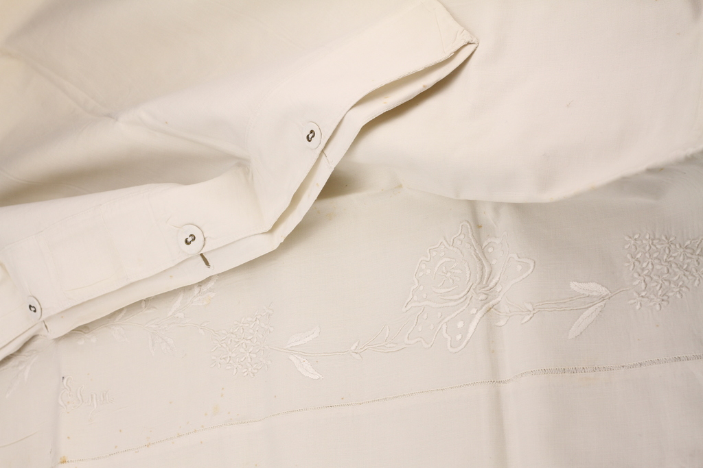 Embroidered pillowcase and other baby bedding details