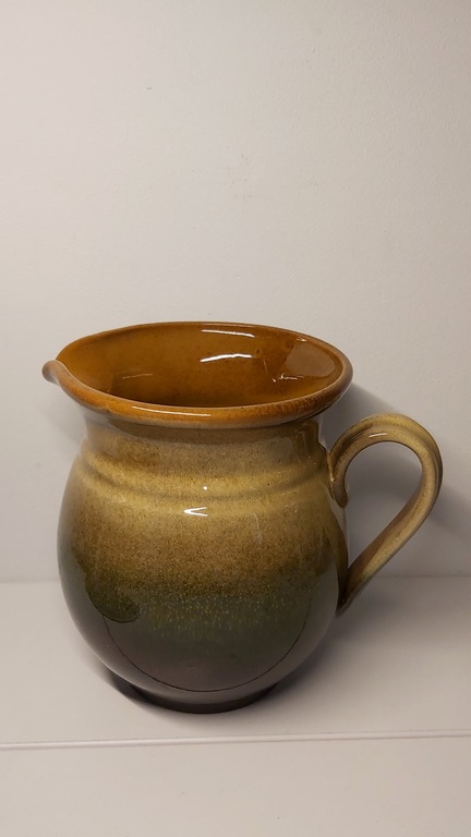 Clay pitcher. Brownish green color.