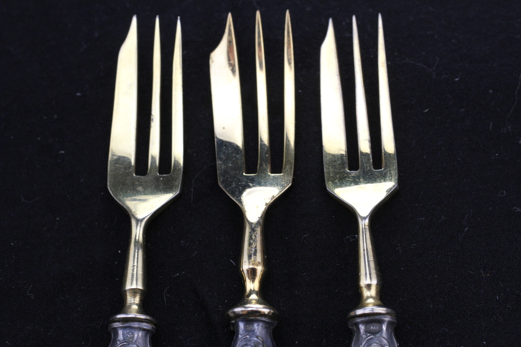 Three gilded dessert forks with silver handles