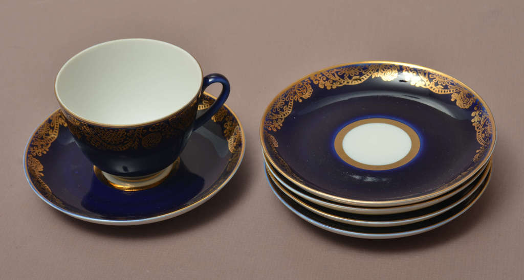 Porcelain cups for five people with saucers