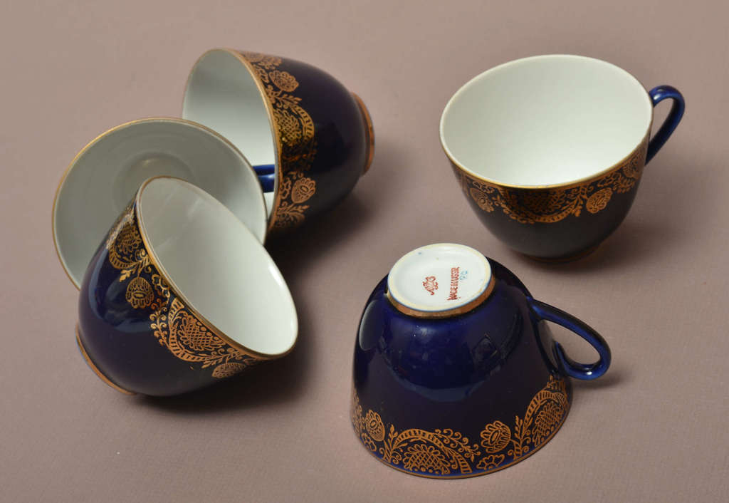 Porcelain cups for five people with saucers