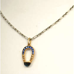 Gold horseshoe with diamonds, sapphire and chain