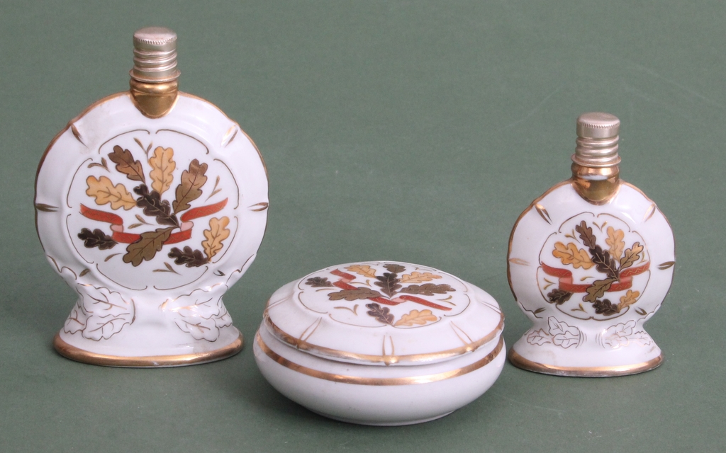 Two porcelain perfume bottles and a box/chest 