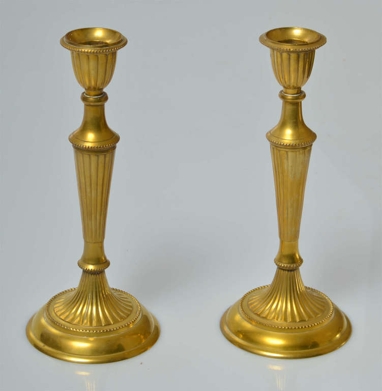 2 bronze candlesticks and a candle extinguisher