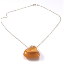 Vintage Yellow amber pendant on a silver chain.