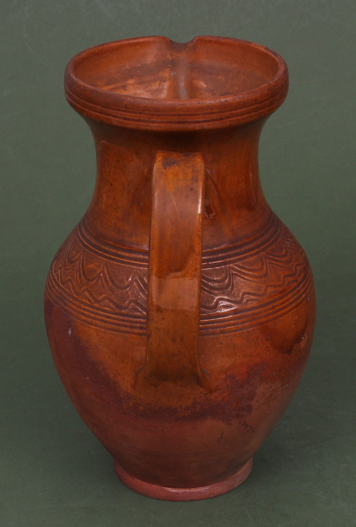 Ceramic pitcher with ornament