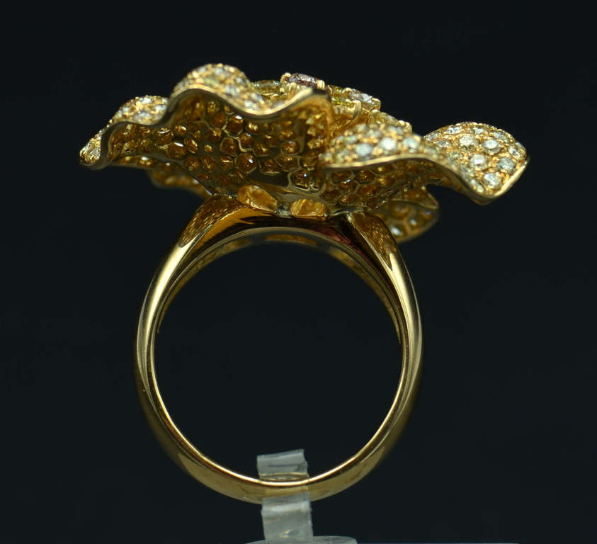 Gold ring in the shape of a flower with diamonds