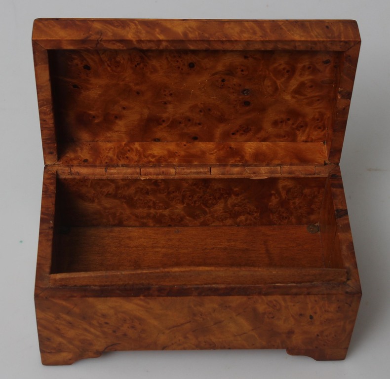 A wooden casket with a pipe