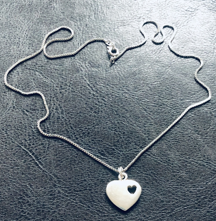 Silver pendant with chain. The 80s.
