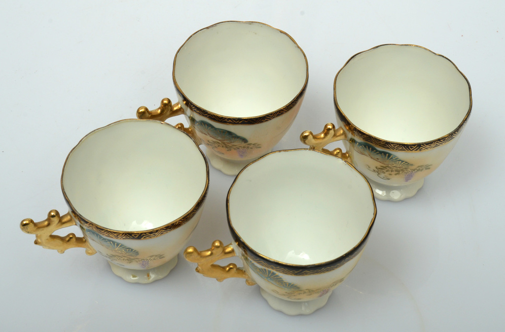 Vintage Japanese porcelain cups with gilt painting and a beautiful curved gilt handle
