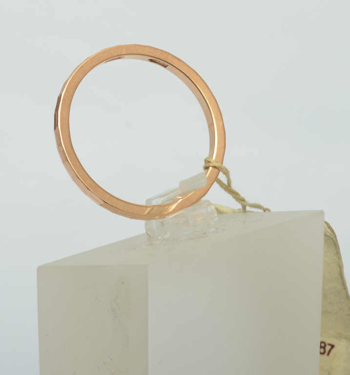 A gold ring with a faceted finish