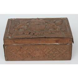 A wooden chest with a copper finish with the coat of arms of Latvia