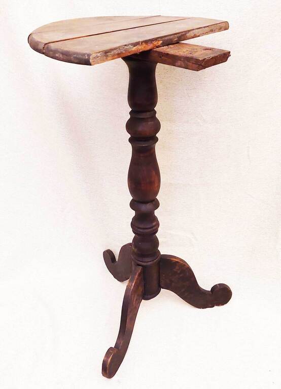 A restorable wooden table with a turned leg