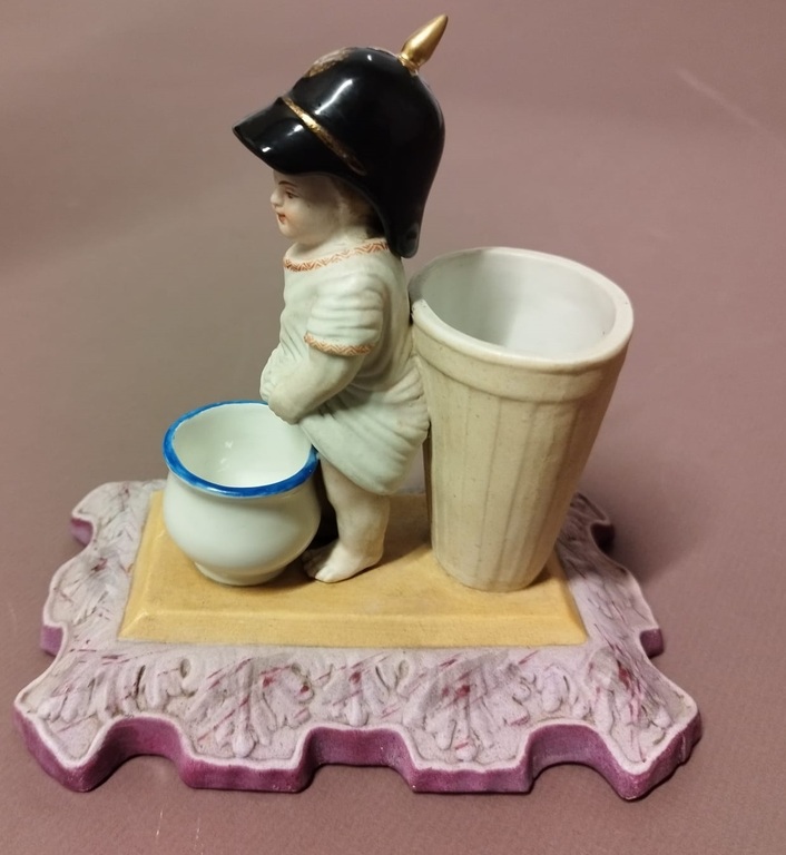 Biscuit figurine with a sculpture of a peeing boy