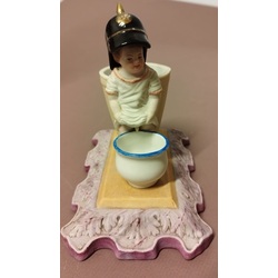 Biscuit figurine with a sculpture of a peeing boy