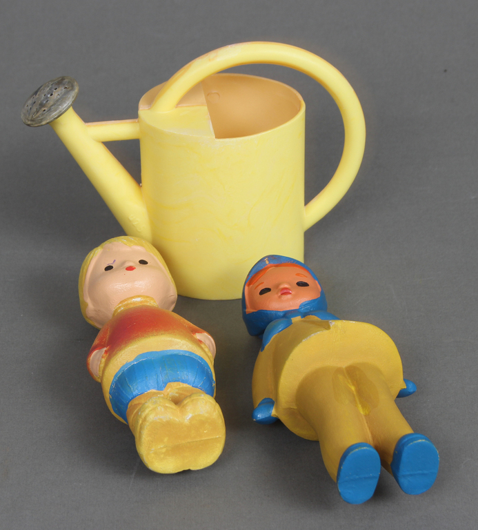 Two baby toys and a watering can