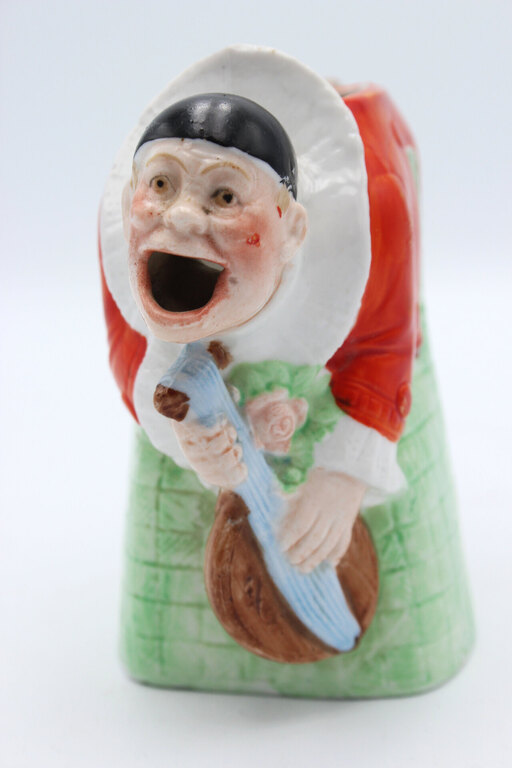 Antique art-deco style milk-cream can Pierrot the Clown plays the mandolin
