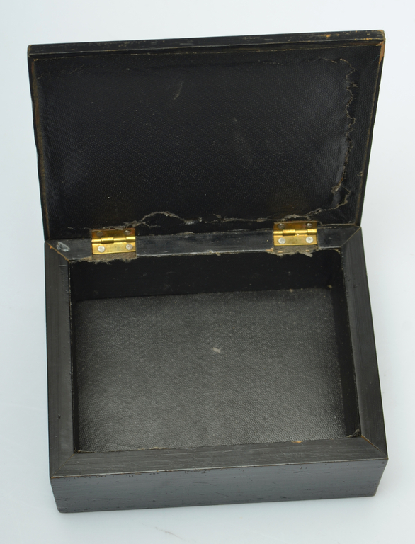 A wooden casket with a glass lid and a miniature