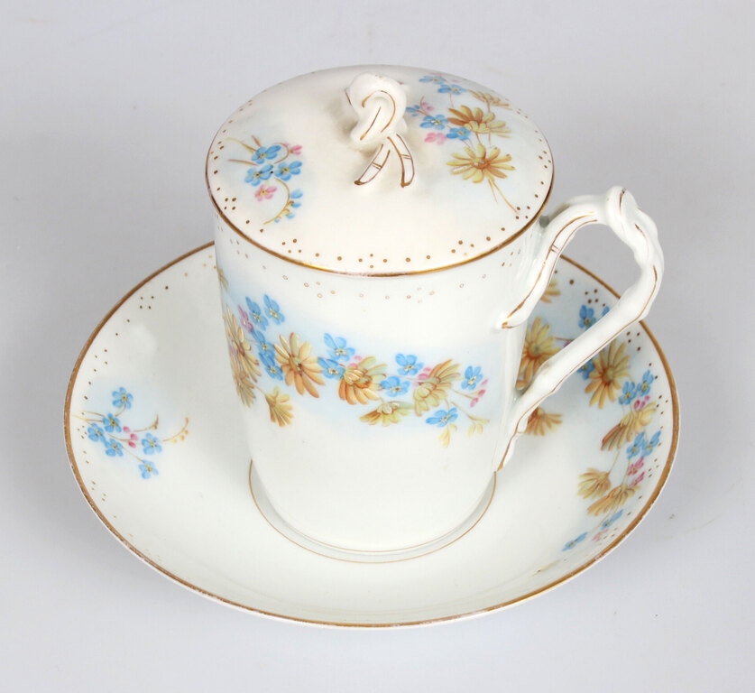 Painted porcelain cup with saucer and lid