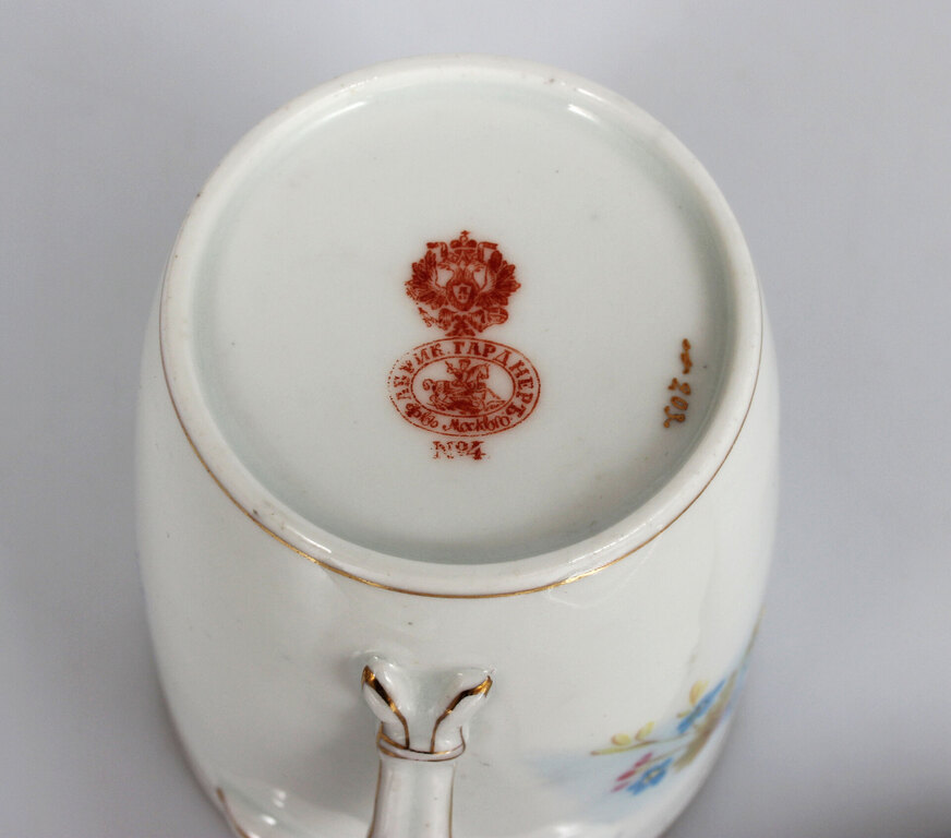 Painted porcelain cup with saucer and lid