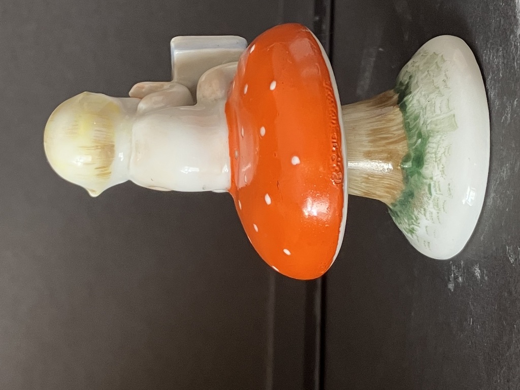 porcelain figurine boy on a mushroom
