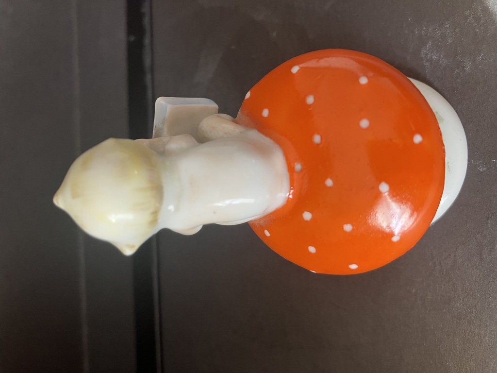 porcelain figurine boy on a mushroom