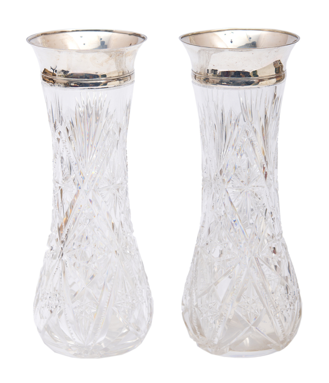 A pair of crystal vases with silver trim