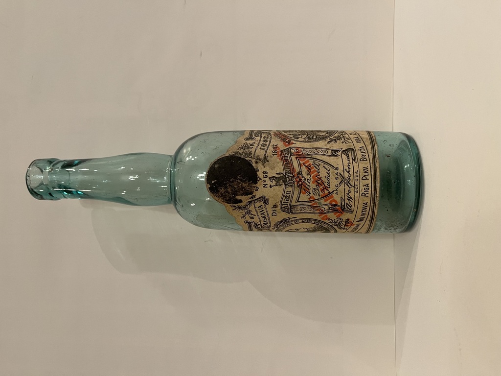 A bottle with a label: Allaž cumin