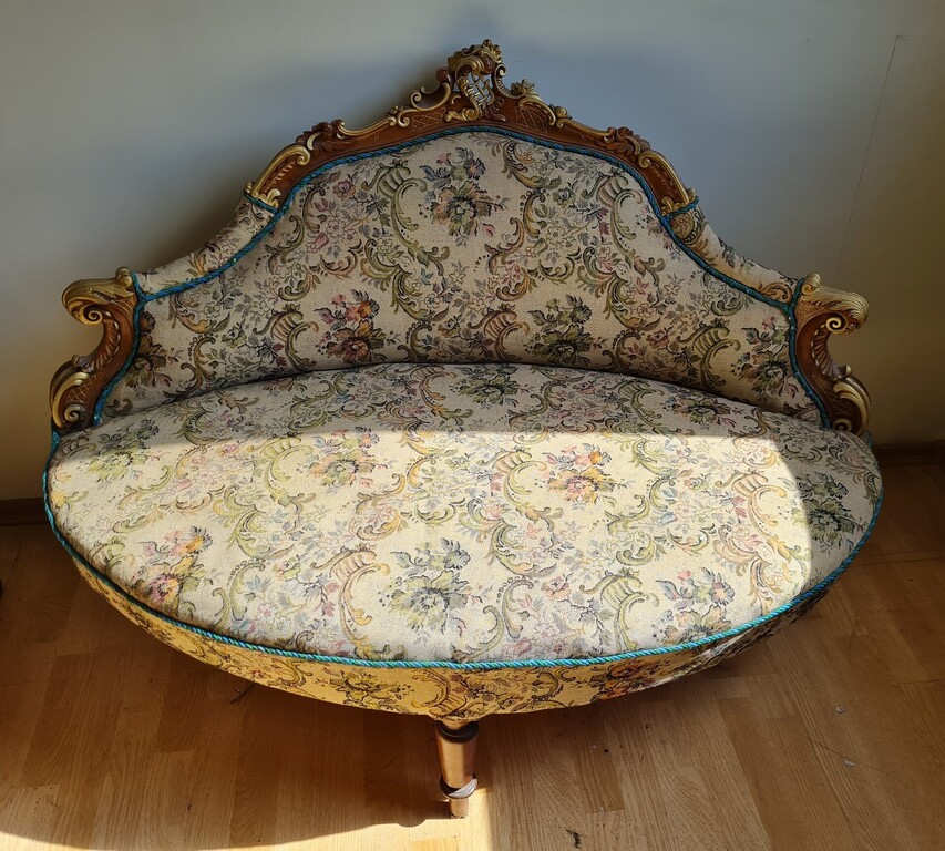 A small sofa with gilded decorations