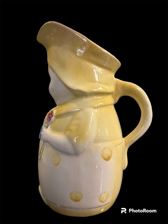 Mug Big Annele = yellow color with dotted dress holding flowers. approximately 70 years old