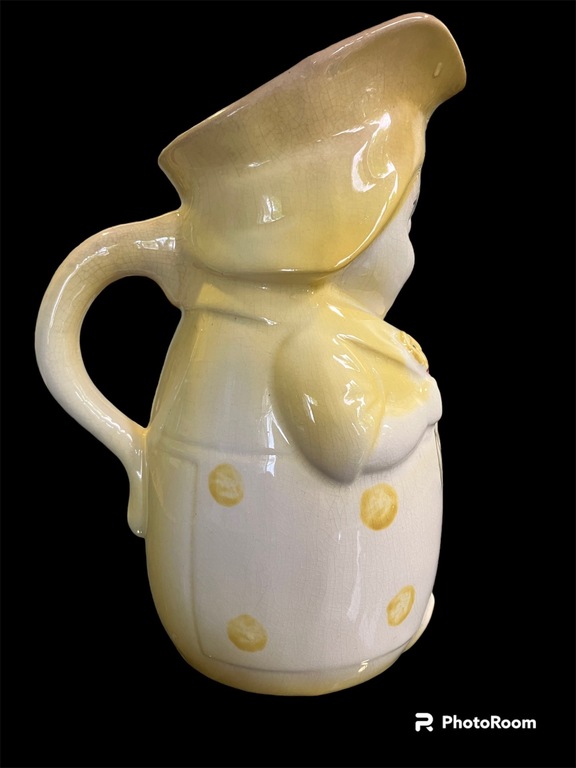 Mug Big Annele = yellow color with dotted dress holding flowers. approximately 70 years old