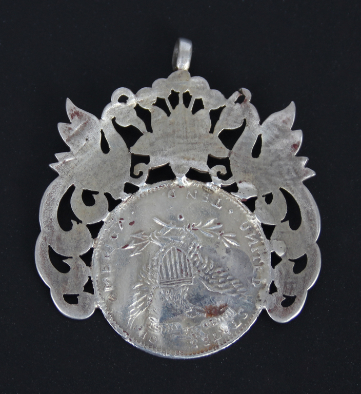 Silver pendant made from an 1881 silver 10 dollar coin