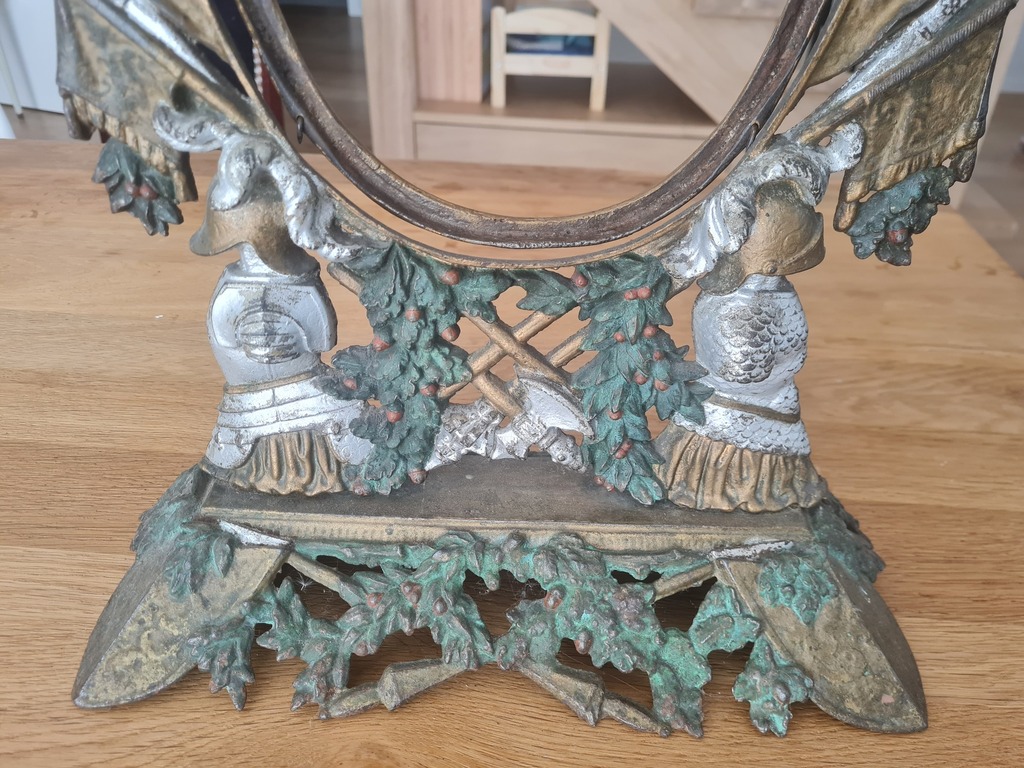 Metal frame with ornate heraldry