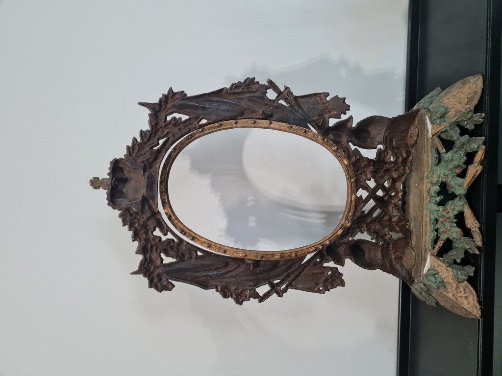 Metal frame with ornate heraldry