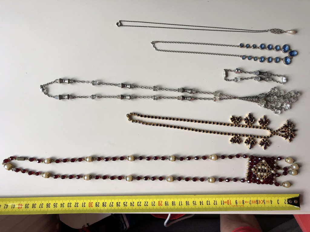 Five costume jewelry necklaces and a bracelet
