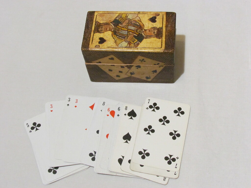 Wooden box for playing cards, together with an incomplete set of cards, 8,7.6.5..3.2. and the Joker.