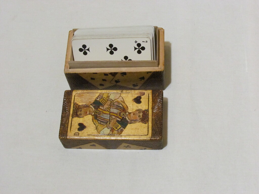 Wooden box for playing cards, together with an incomplete set of cards, 8,7.6.5..3.2. and the Joker.