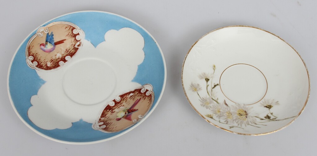 A porcelain cup with a defect and two plates