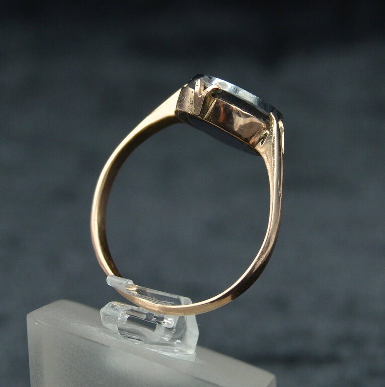 Gold ring with black cut stone